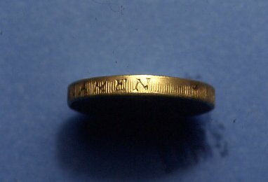 Edge of a 1996 dated one-pound
 counterfeit. It shows some of the millings have not been made.